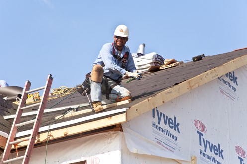 Waukegan Roofing employee working on residential roof